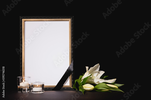Obraz na płótnie lily, candles and mirror with ribbon on black , funeral concept