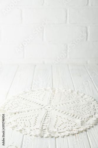 Fragment of a vintage napkin, tied with white thread, on a wooden table. Copy space, mock up...