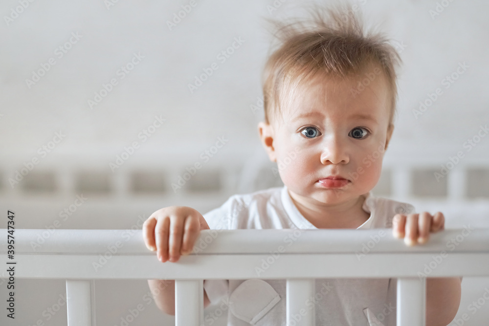 baby child standing in the crib