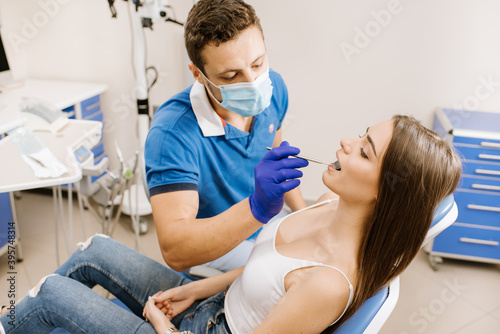 Dentist checking patient's teeth with instruments