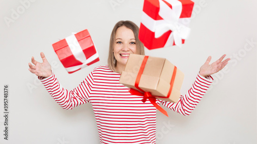 Obraz na plátně Young excited woman throwing up the gift boxes.