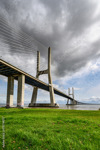 Famous Vasco da Gama Bridge in Sacavem, Portugal under the cloudy sky photo