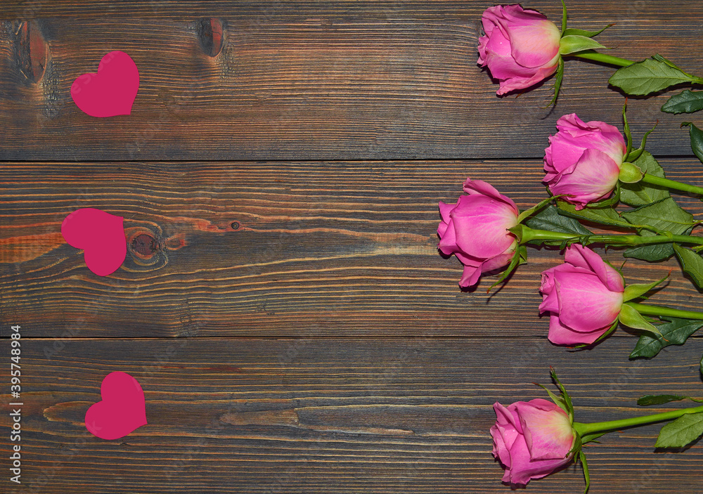 Pink roses on a wooden background, a table. View from above. The concept of a floral background, Valentine's day