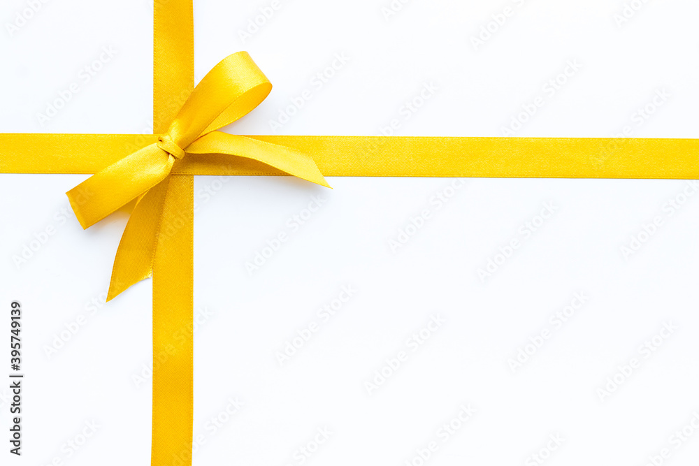 Golden ribbon with bow isolated on white. Top view Golden ribbon with bow isolated on white. Top view