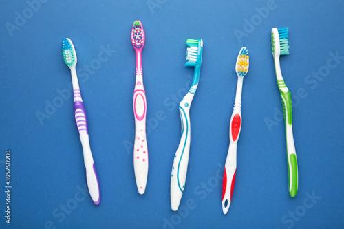 Toothbrushes on dark blue background. Top view