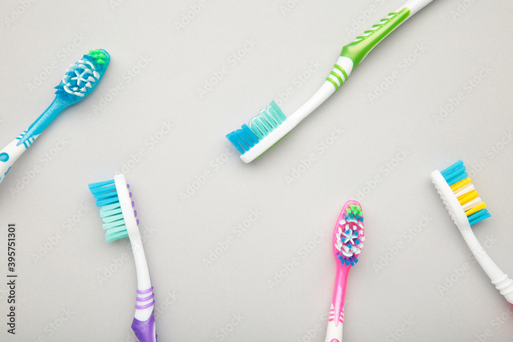 Toothbrushes on a grey background. Top view Toothbrushes on a grey background. Top view
