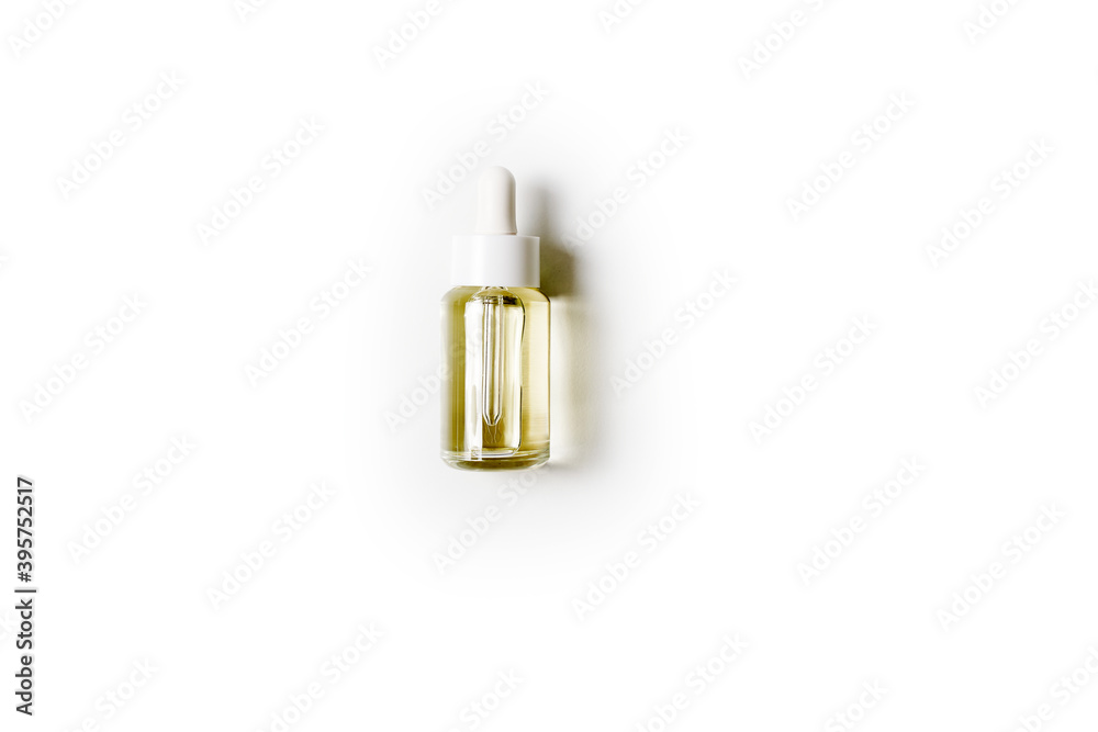 flat lay cosmetic transparent bottle with oil on grey and yellow color paper background. High quality photo flat lay cosmetic transparent bottle with oil on grey and yellow color paper background. High quality photo