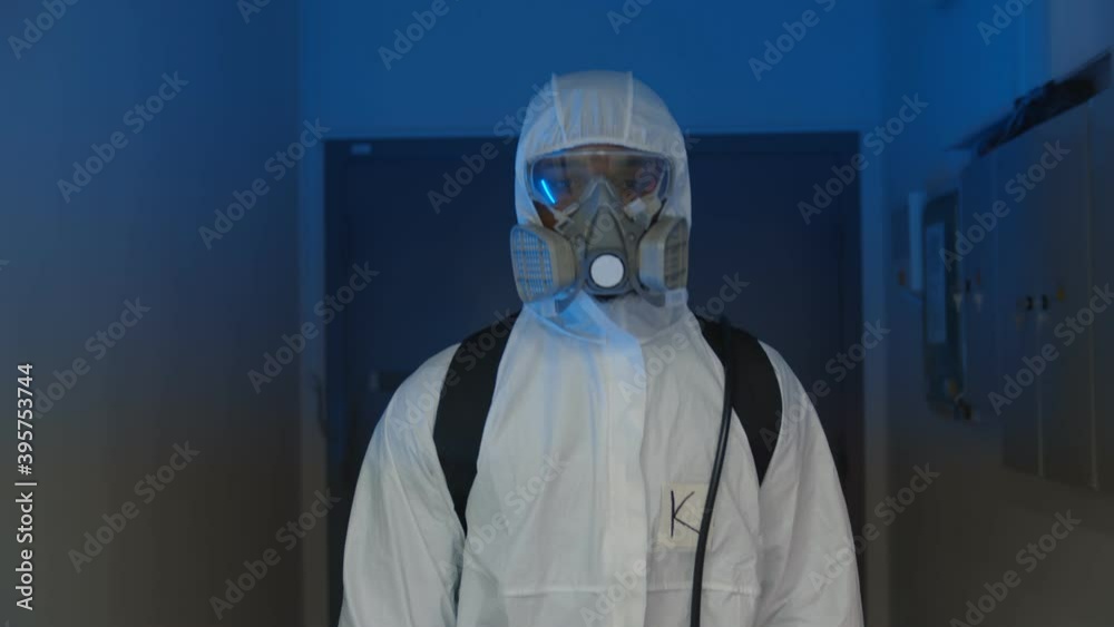 Portrait of doctor in protective overall walking in corridor of clinic. Portrait of doctor in protective overall walking in corridor of clinic.