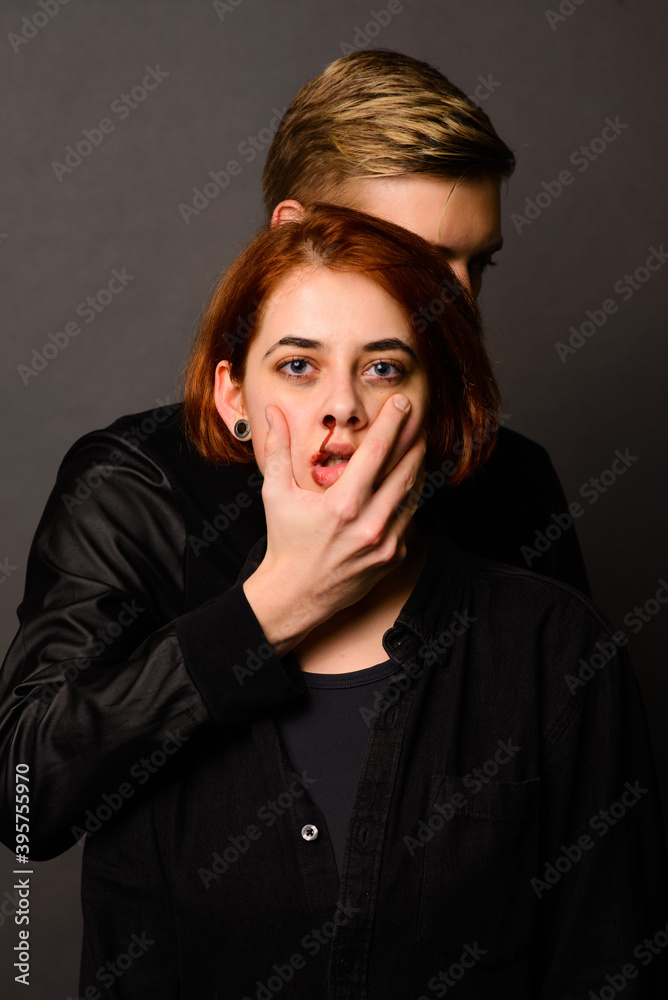 Desparate young woman with aggressive man in studio, domestic violence conception Desparate young woman with aggressive man in studio, domestic violence conception
