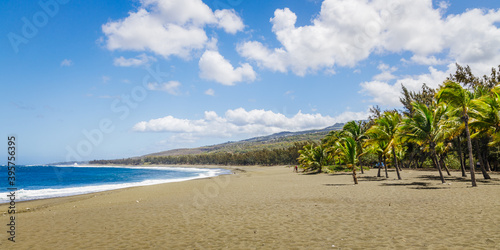 Etang-Sale beach on Reunion Island with its characteristic black sand and the waves of the Indian Ocean