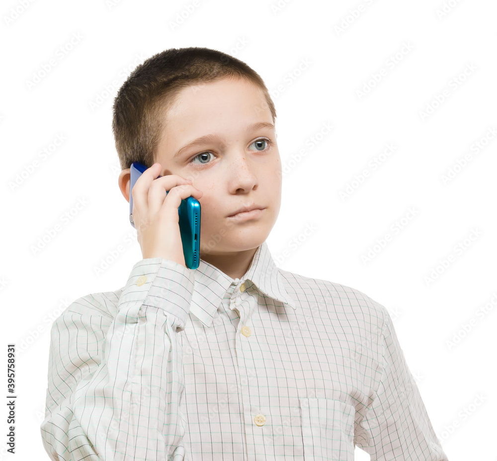 serious boy in shirt talking on a cell phone on a white background serious boy in shirt talking on a cell phone on a white background