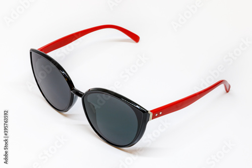 sunglasses with red temples on a white background