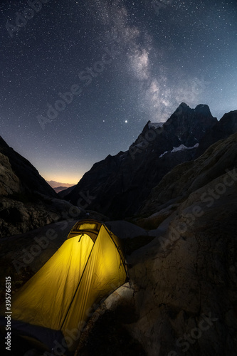 Sleeping with the tent under the Milky Way and the many stars in the French Alps near Mont Pelvoux. Mont Pelvoux is a mountain in the French Pelvoux massif in the Écrins National Park.