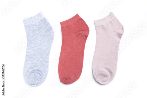 several colored new short socks on a white background, top view