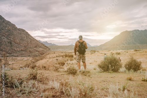 hiker man with backpack standing outdoors