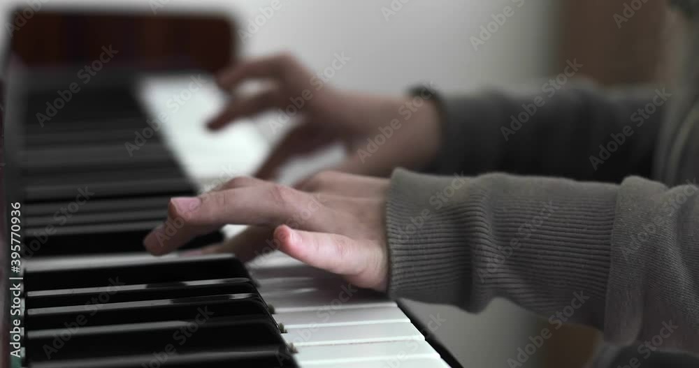 Close up of girls hands playing the piano. Music lessons. Hobby. Close up of girls hands playing the piano. Music lessons. Hobby.