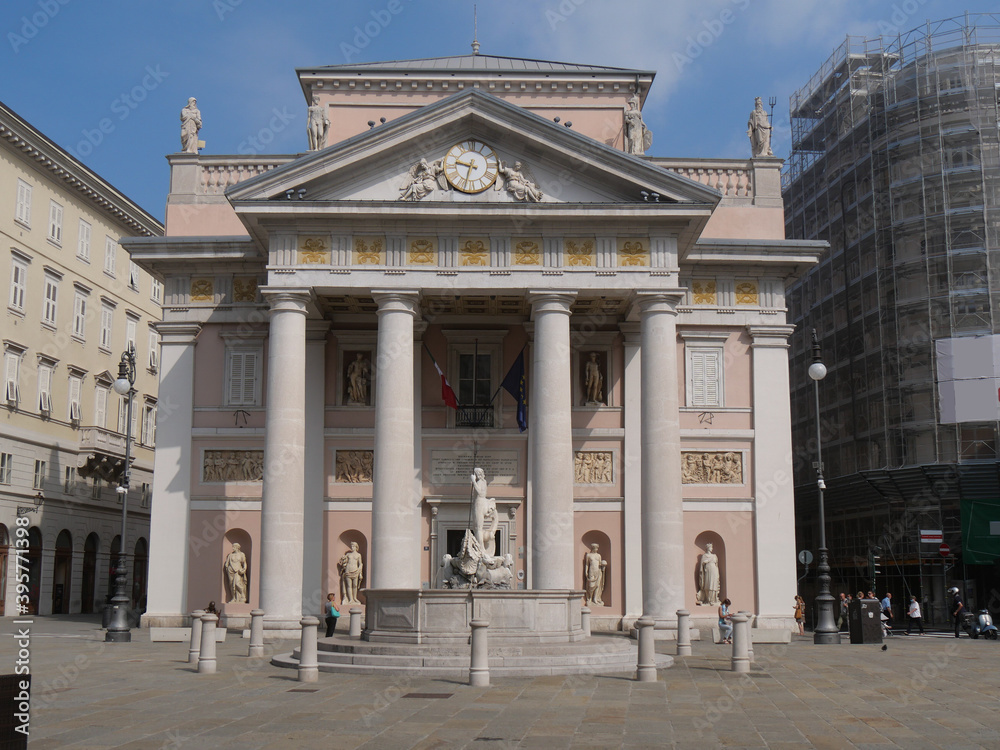 Obraz premium Palazzo della Borsa in Trieste, exterior looks like a Greek Doric temple with columns in neoclassical style and fountain of Neptune in front