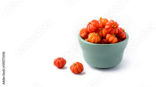 Surinam Cherries or Pitanga Fruits in a cup. White Background photo