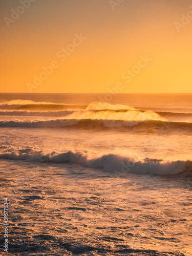 Perfect waves at sunset or sunrise. Big waves for surfing in Bali