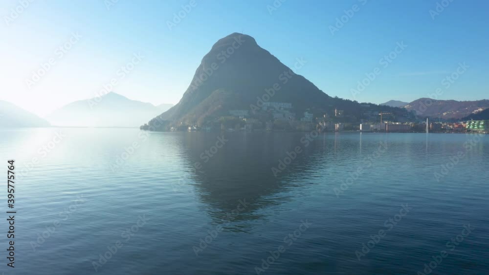 Aerial view of Lugano lake with San Salvatore on background. Dolly out of aerial shoot with drone in Switzerland. Nobody inside Aerial view of Lugano lake with San Salvatore on background. Dolly out of aerial shoot with drone in Switzerland. Nobody inside