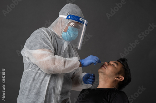 Photography male with Personal protective equipment testing a swab for pandemic