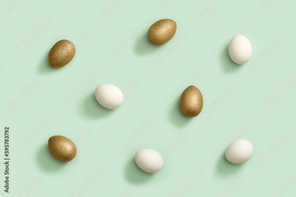 Decorated Easter golden and white eggs on green background. Happy Easter pattern.
