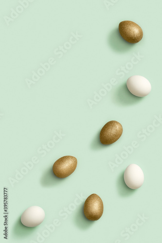 Decorated Easter golden and white eggs on green background. Happy Easter card, postcard