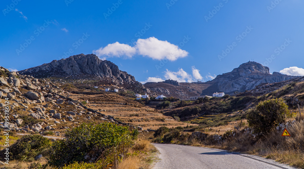 Panoramic view of road and rocky landscapes in the foothills of Mount Exomvourgo on the island of Tinos, Cyclades, Greece