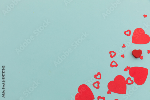 High angle view of red hearts scattered on blue background