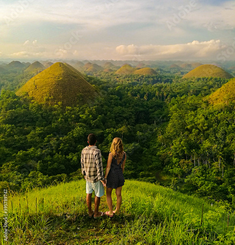 Young couple at the chocolate hills on the island of Bohol, in the Philippines.