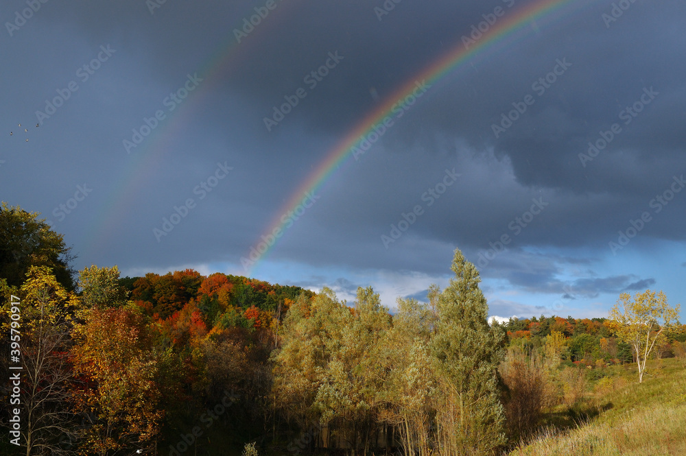 Double rainbow over fall Landscape with rain Double rainbow over fall Landscape with rain