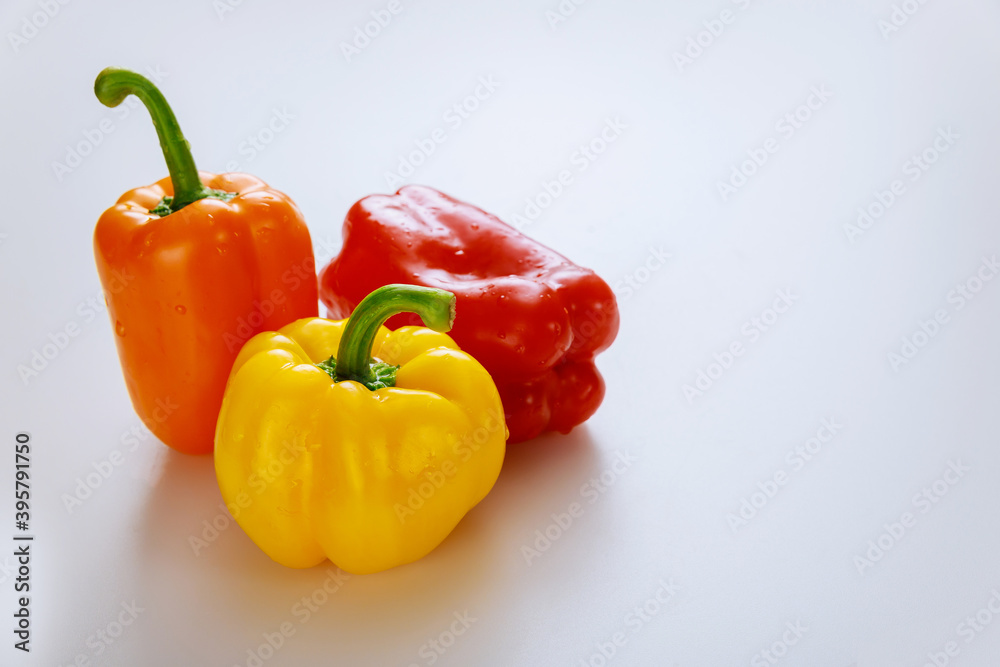 Red, orange and yellow bell peppers isolated on white background. Red, orange and yellow bell peppers isolated on white background.
