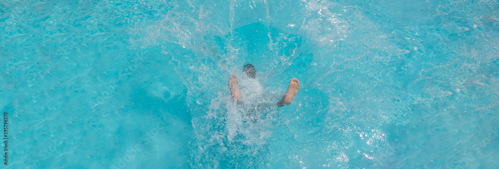 Man falling and splashing into blue water