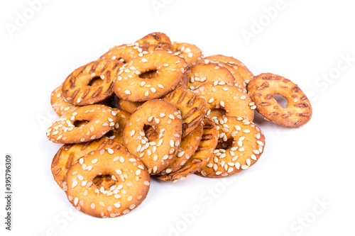 Slika na platnu Pile of salty round pretzel pieces isolated over white
