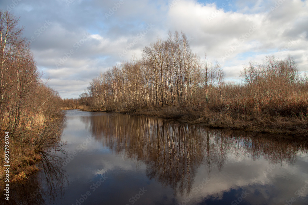 Autumn landscape with trees by the river and cloudy sky Autumn landscape with trees by the river and cloudy sky