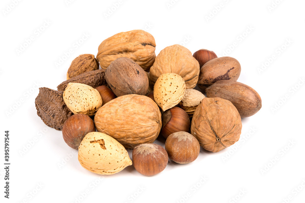 Pile of assorted nuts in the shell isolated over white Pile of assorted nuts in the shell isolated over white