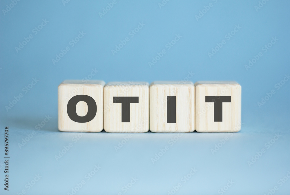 OTIT inscription on wooden cubes on the table, BLUE background. medicine OTIT inscription on wooden cubes on the table, BLUE background. medicine