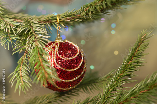 Cropped image of christmas tree with red toy