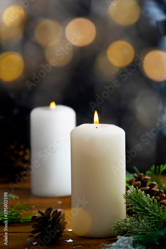 Christmas candles and ornaments, dark background with bokeh lights