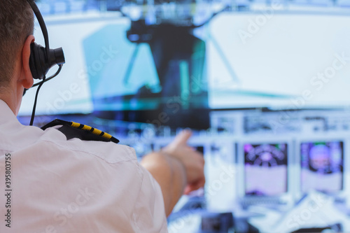 Airline pilot wearing uniform with epauletes photo