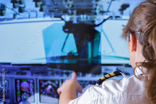 Woman airline pilot wearing uniform with epauletes photo