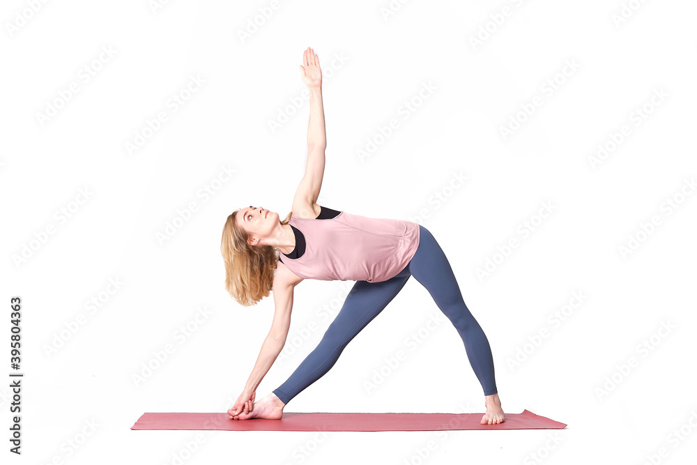middle aged woman yoga asanas. instructor shows a pose from yoga isolated on a white background. woman practicing yoga concept natural balance between body and mental development. middle aged woman yoga asanas. instructor shows a pose from yoga isolated on a white background. woman practicing yoga concept natural balance between body and mental development.
