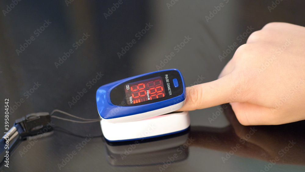 girl checks the pulse and oxygen level in the blood during the corona virus pandemic girl checks the pulse and oxygen level in the blood during the corona virus pandemic
