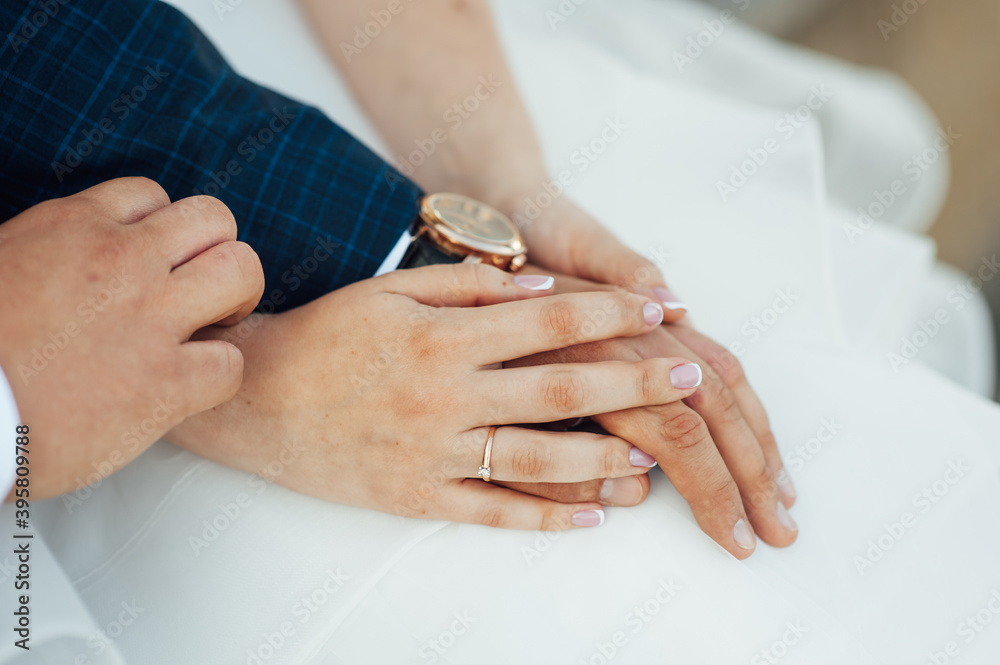 close-up portrait of the bride and groom. They hug their arms. Wedding rings on their hands close-up portrait of the bride and groom. They hug their arms. Wedding rings on their hands