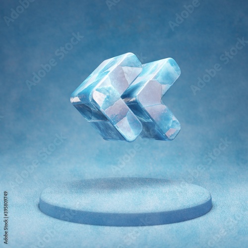 Angle Double Left icon. Cracked blue Ice Angle Double Left symbol on blue snow podium.
