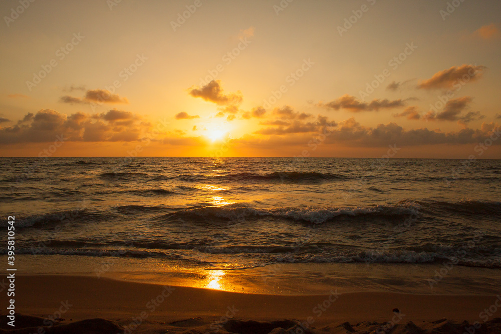 Sunset on the beach of the Tyrrhenian sea in Tuscany, Italy,