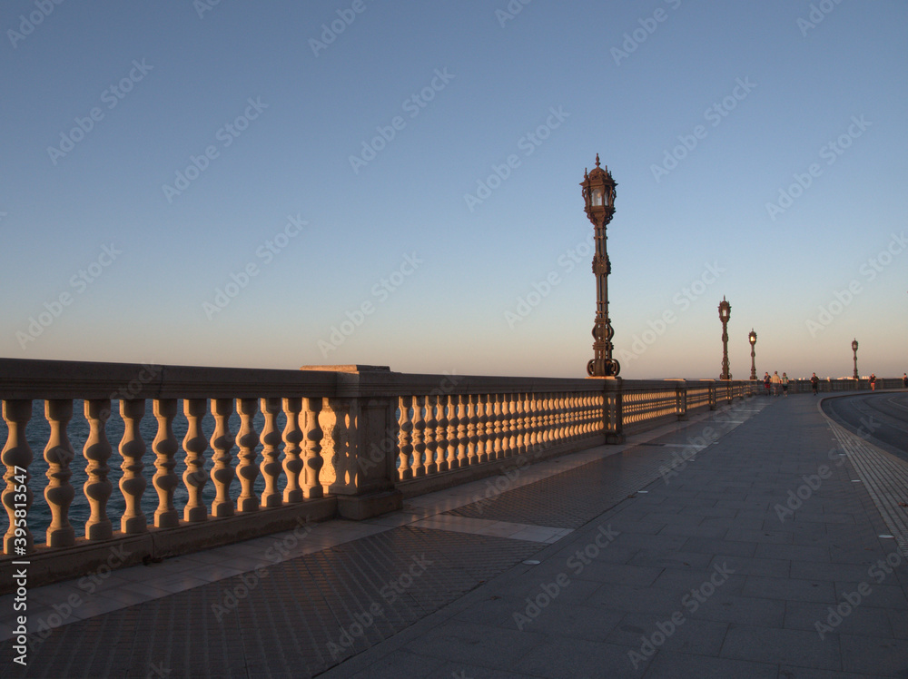 
Balustrade and lampposts on promenade, overlooking the sea, in the old town of cadiz, andalusia, spain
