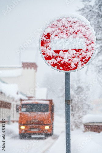 No entry road sign during snowfall photo