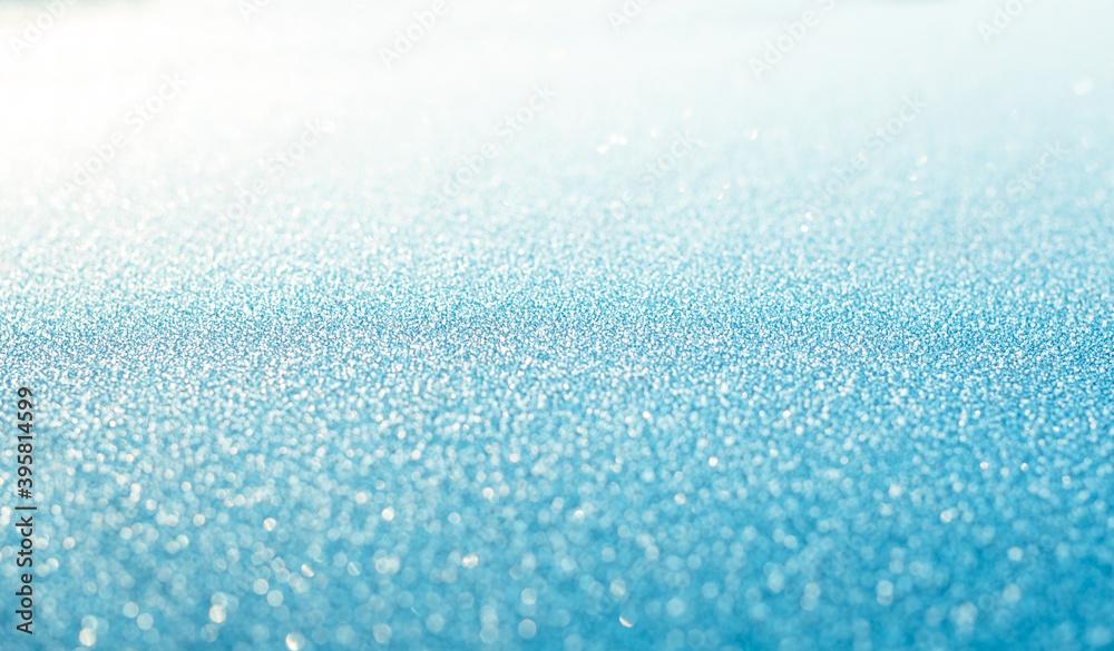 Blue snow sparkling festive background. Abstract 
