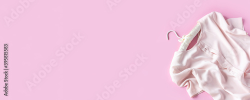 Wallpaper Mural Pink woman blouse is hanging on beautiful hanger on pink background with copy space. Sale and shopping concept. Banner Torontodigital.ca